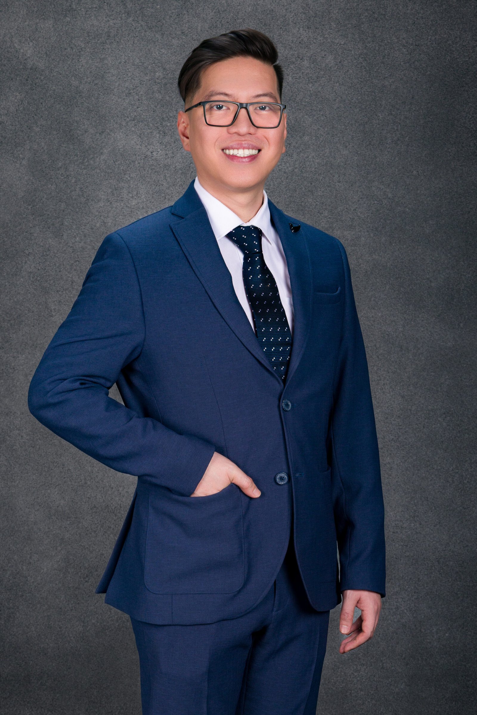 Studio business portrait of a smiling man in a blue suit