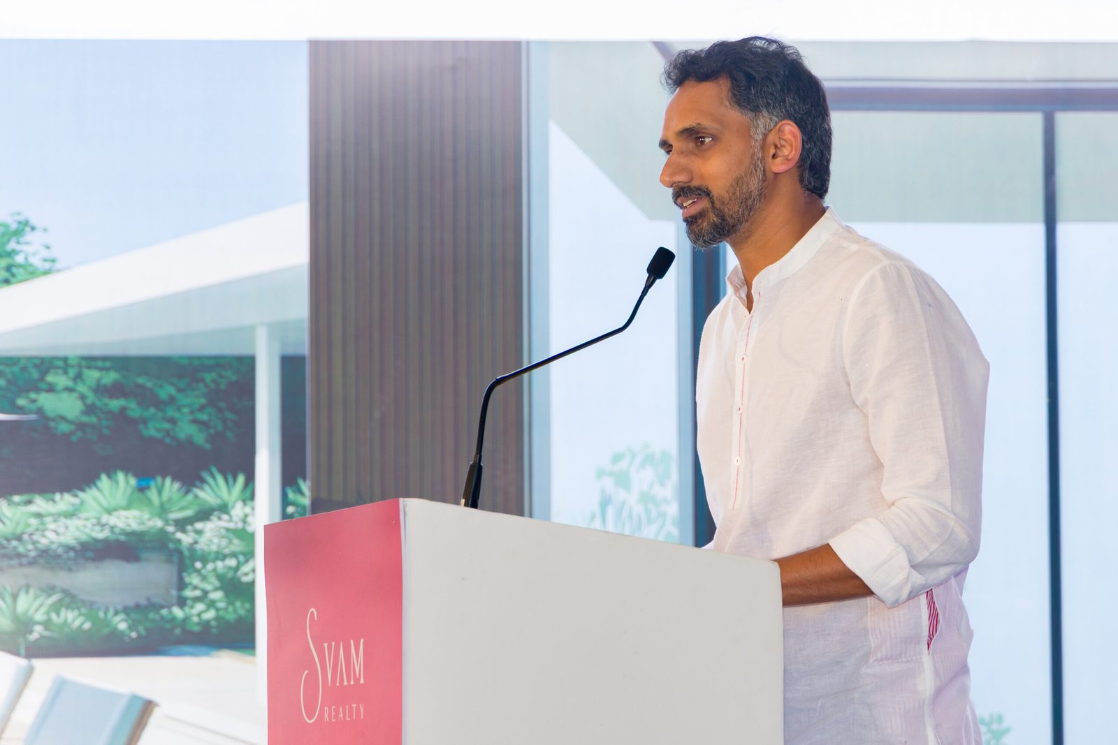 Speaker addressing guests from a lectern at a business event