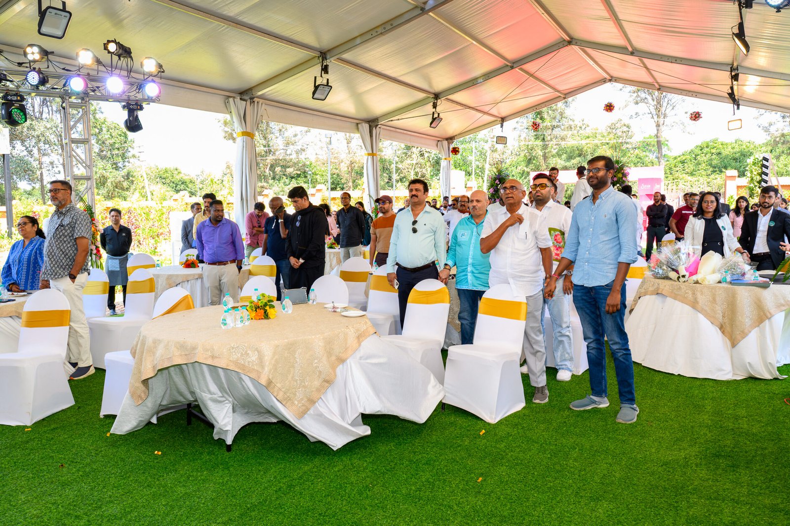 Guests gathered beneath an event marquee with round tables