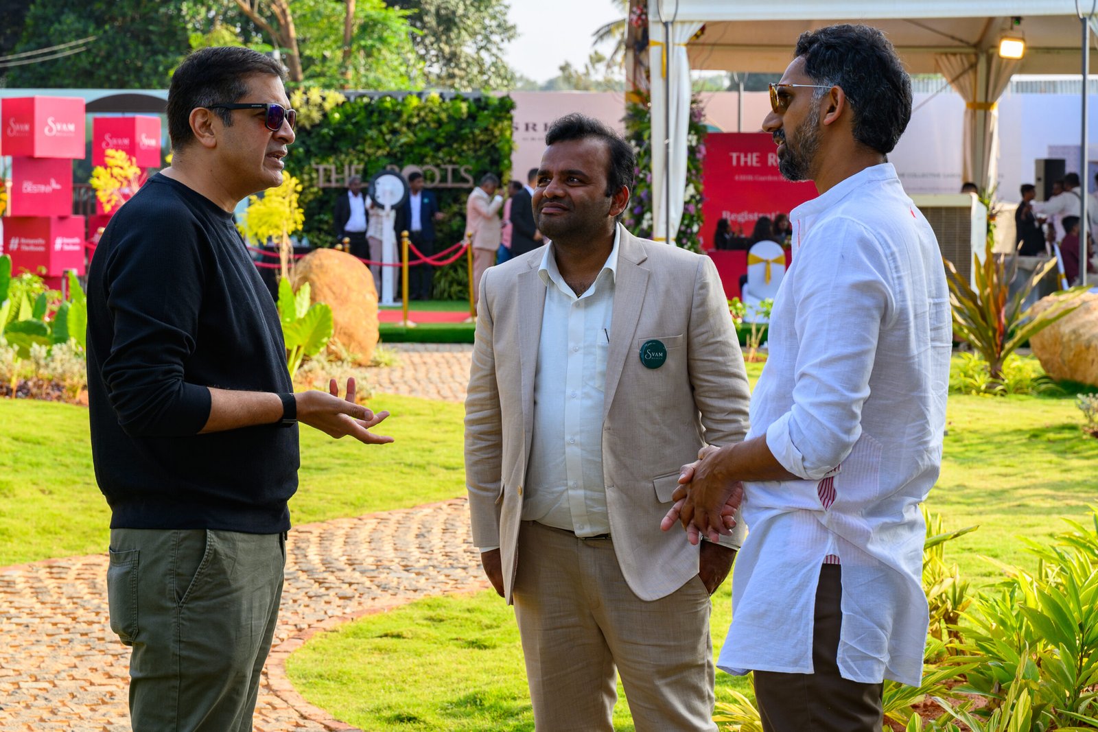 Guests in conversation on a lawn during a business event