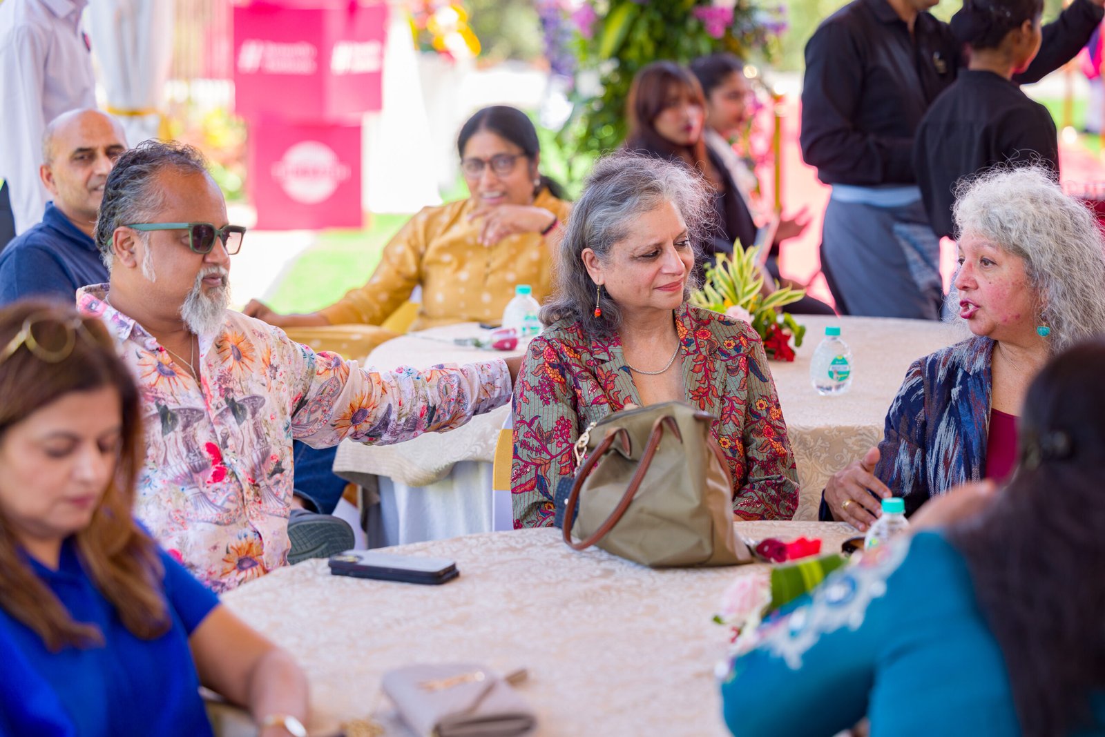 Guests seated together at a table during an outdoor event