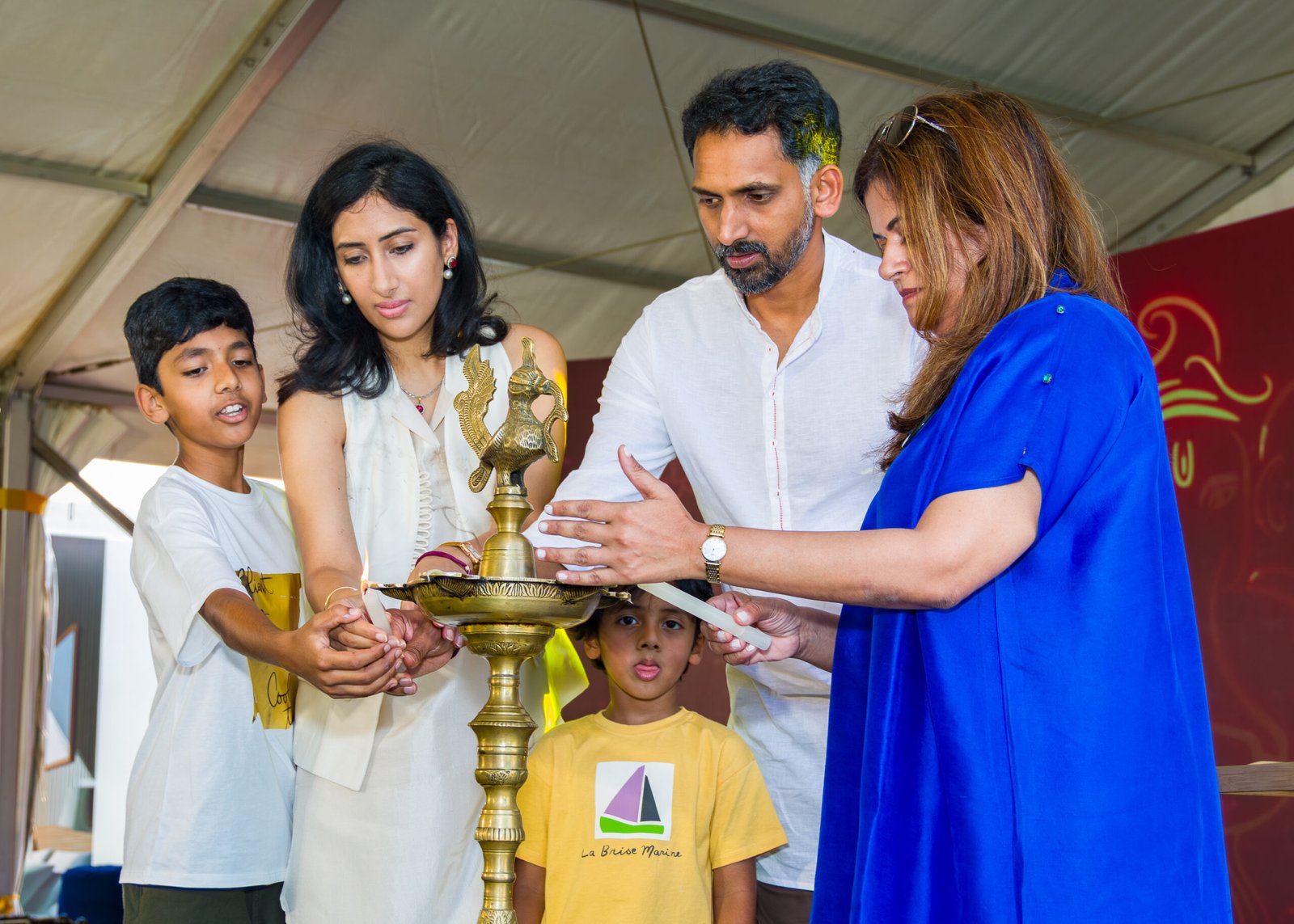 Guests taking part in a ceremonial lamp lighting at an event