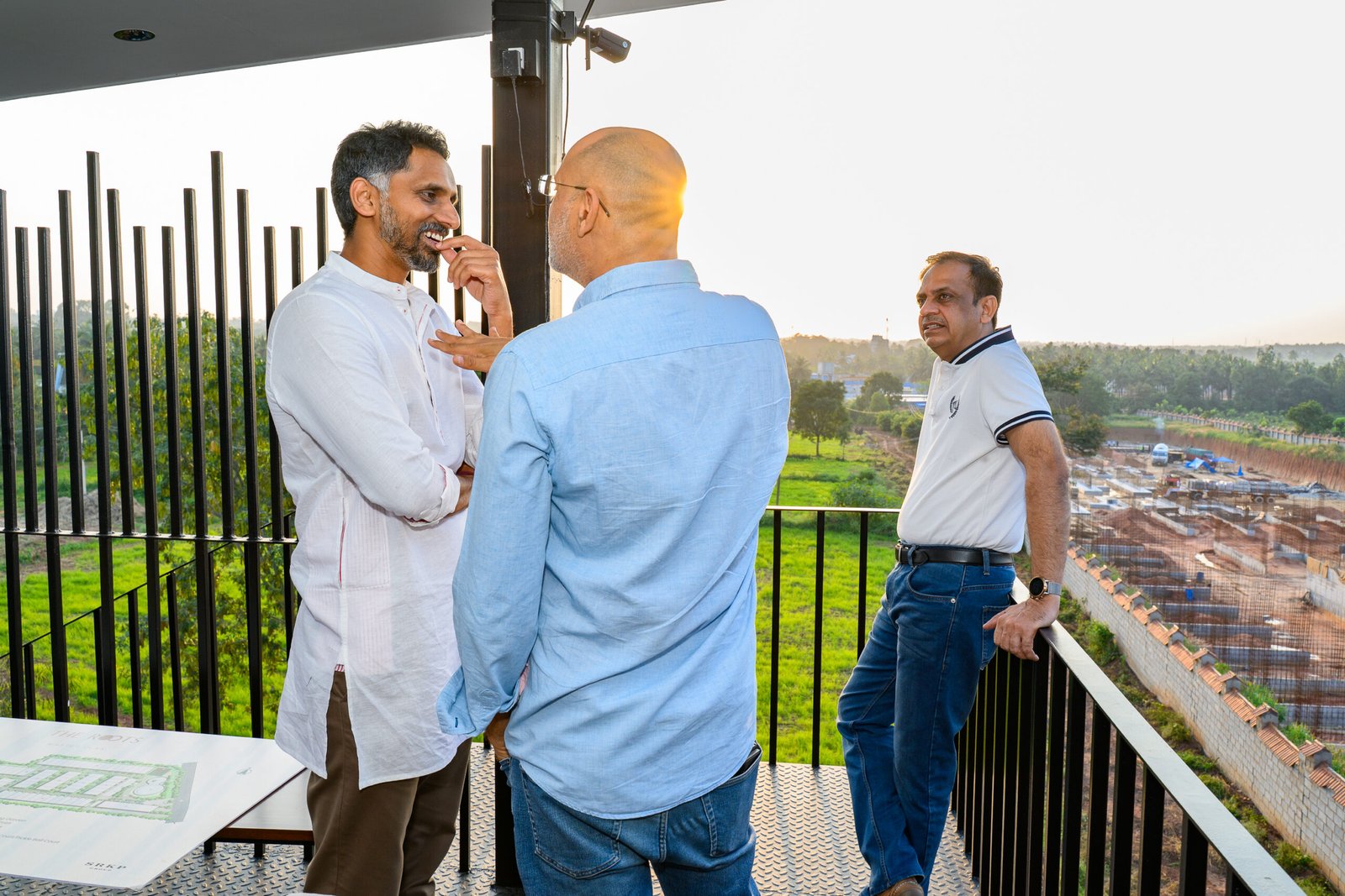 Guests talking on a balcony during a property launch