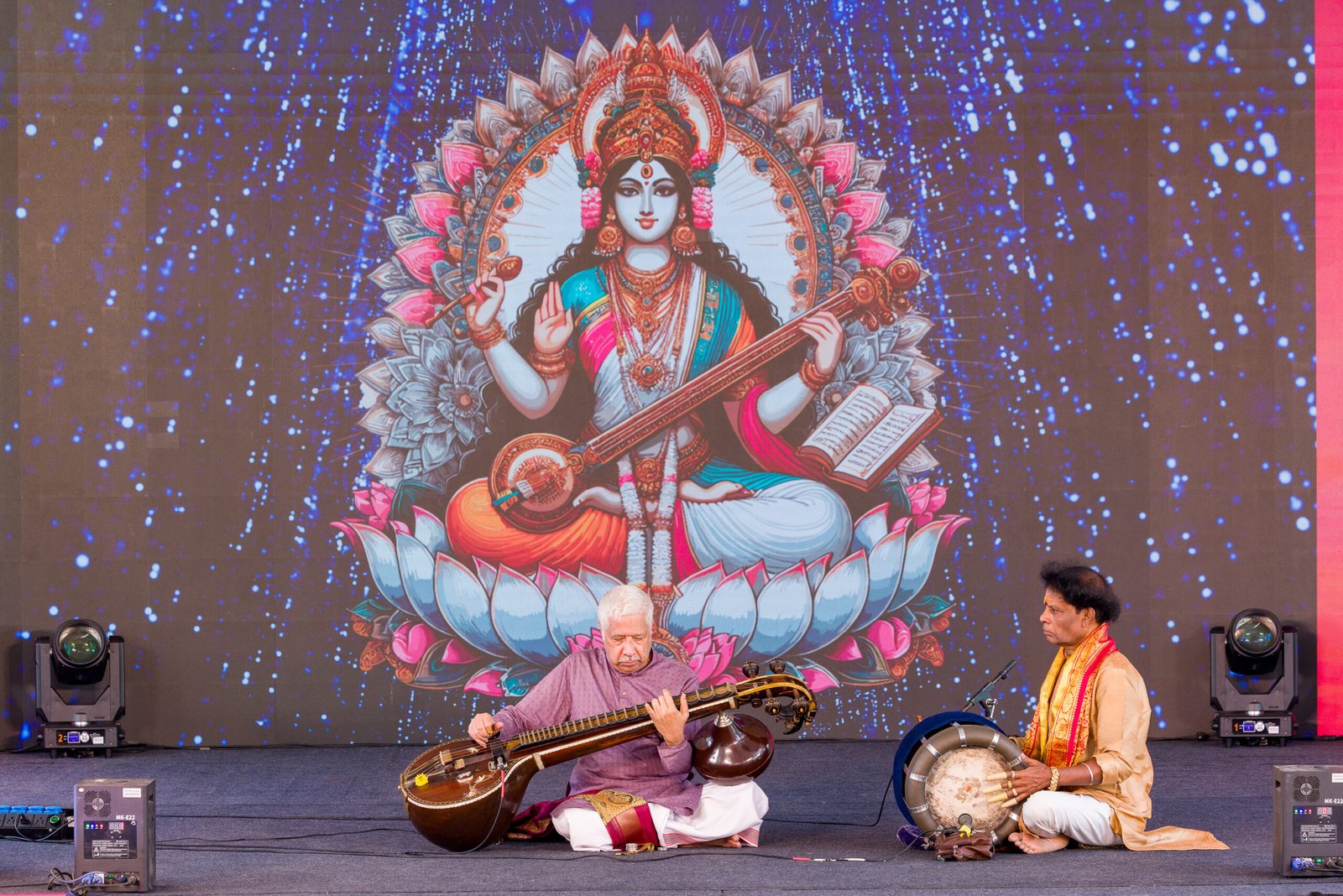 Musicians performing on a decorated event stage