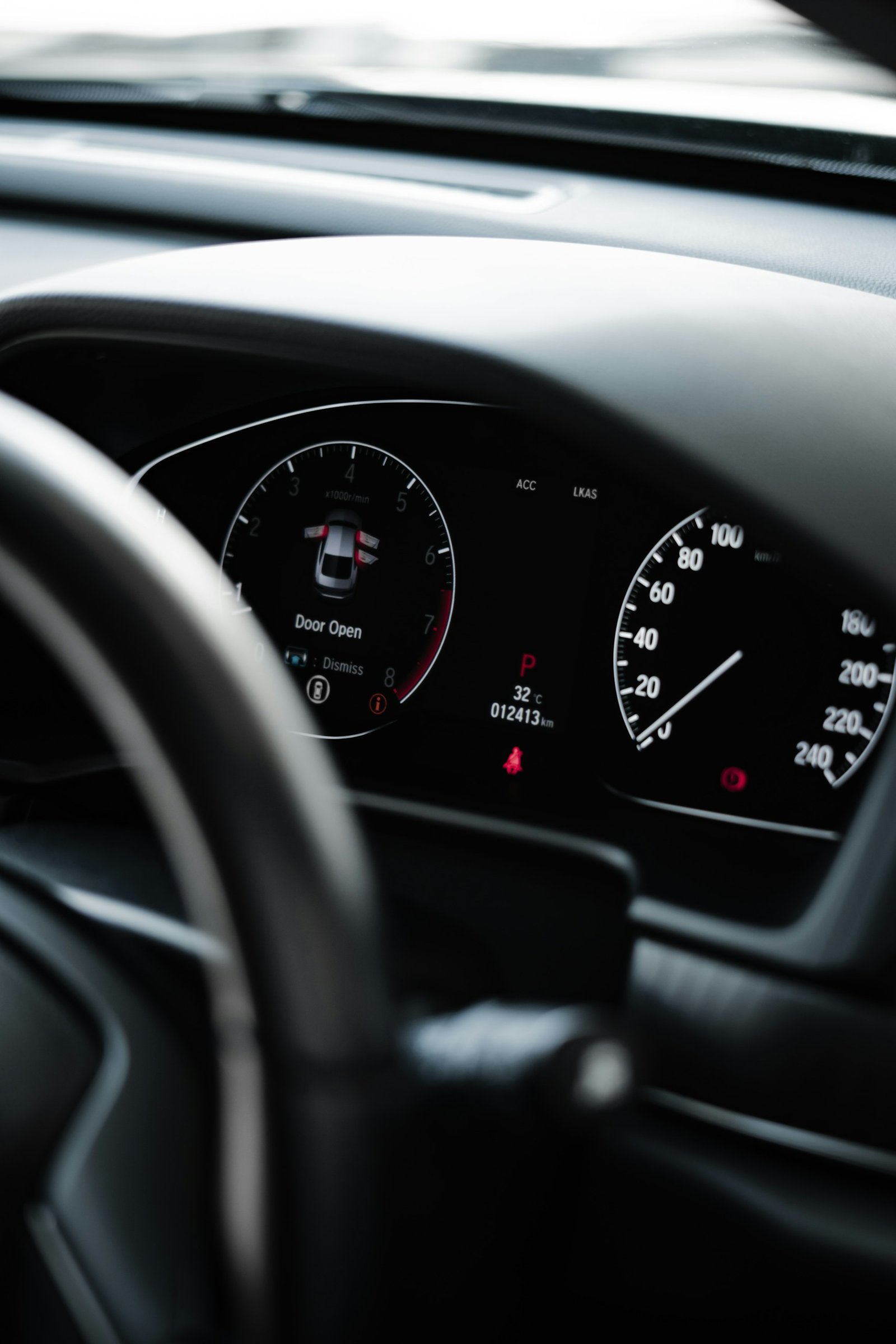Car steering wheel and dashboard detail