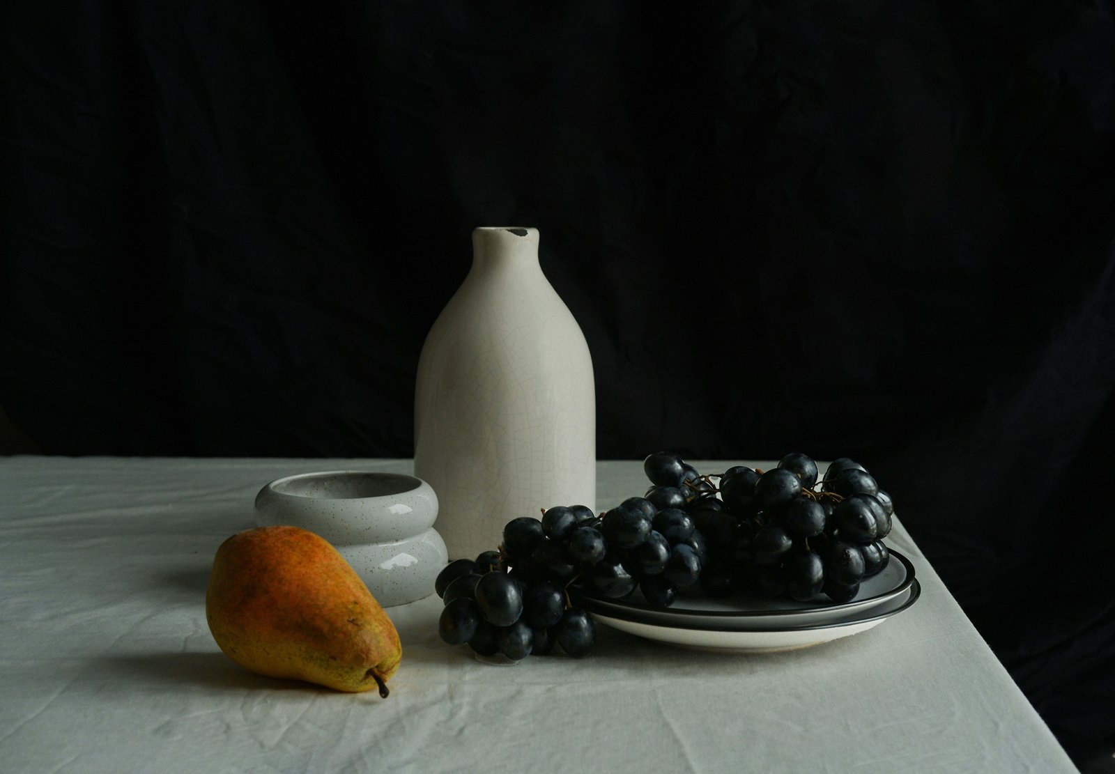 Ceramic vessels and fruit on a table
