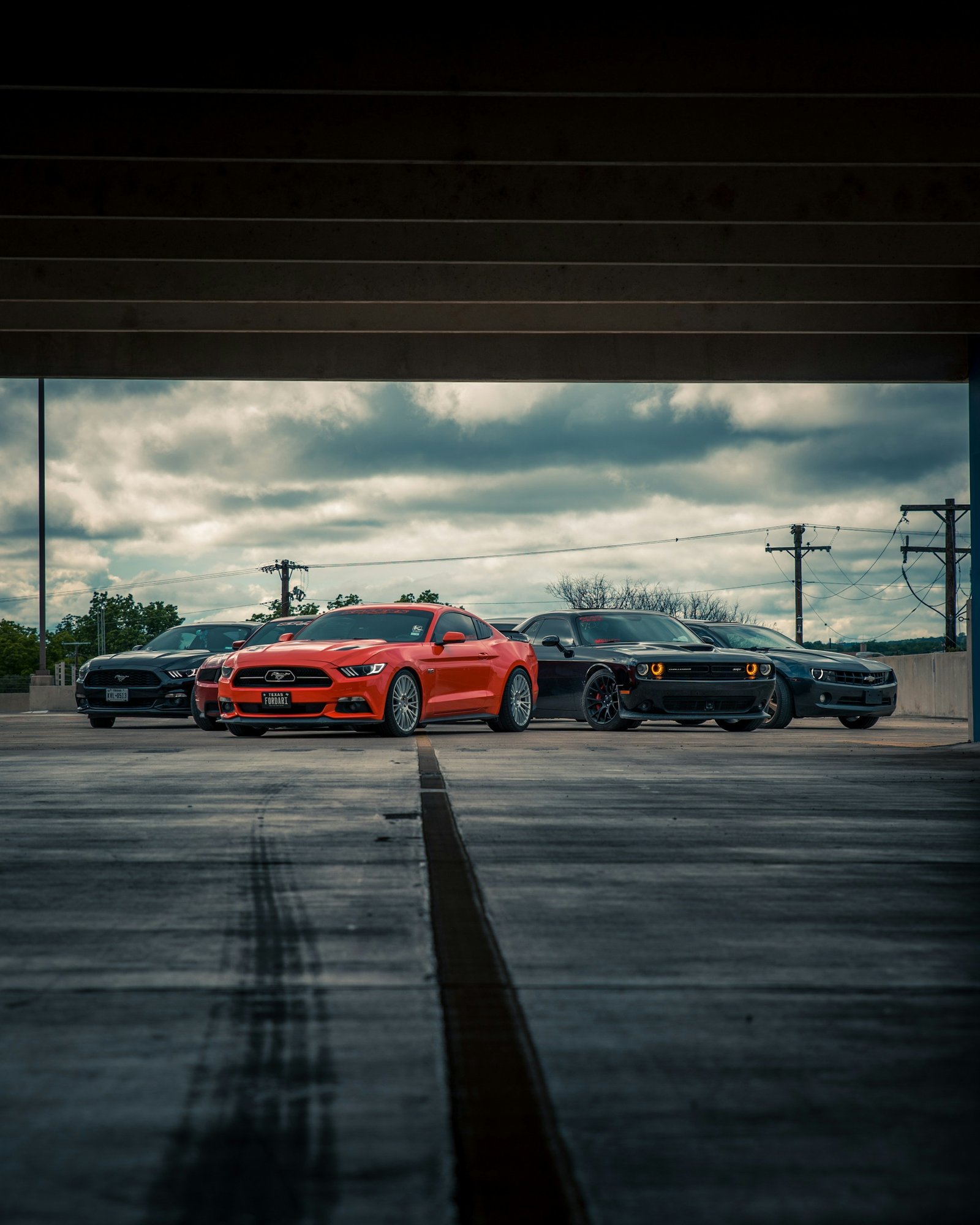 Performance cars beneath an overpass