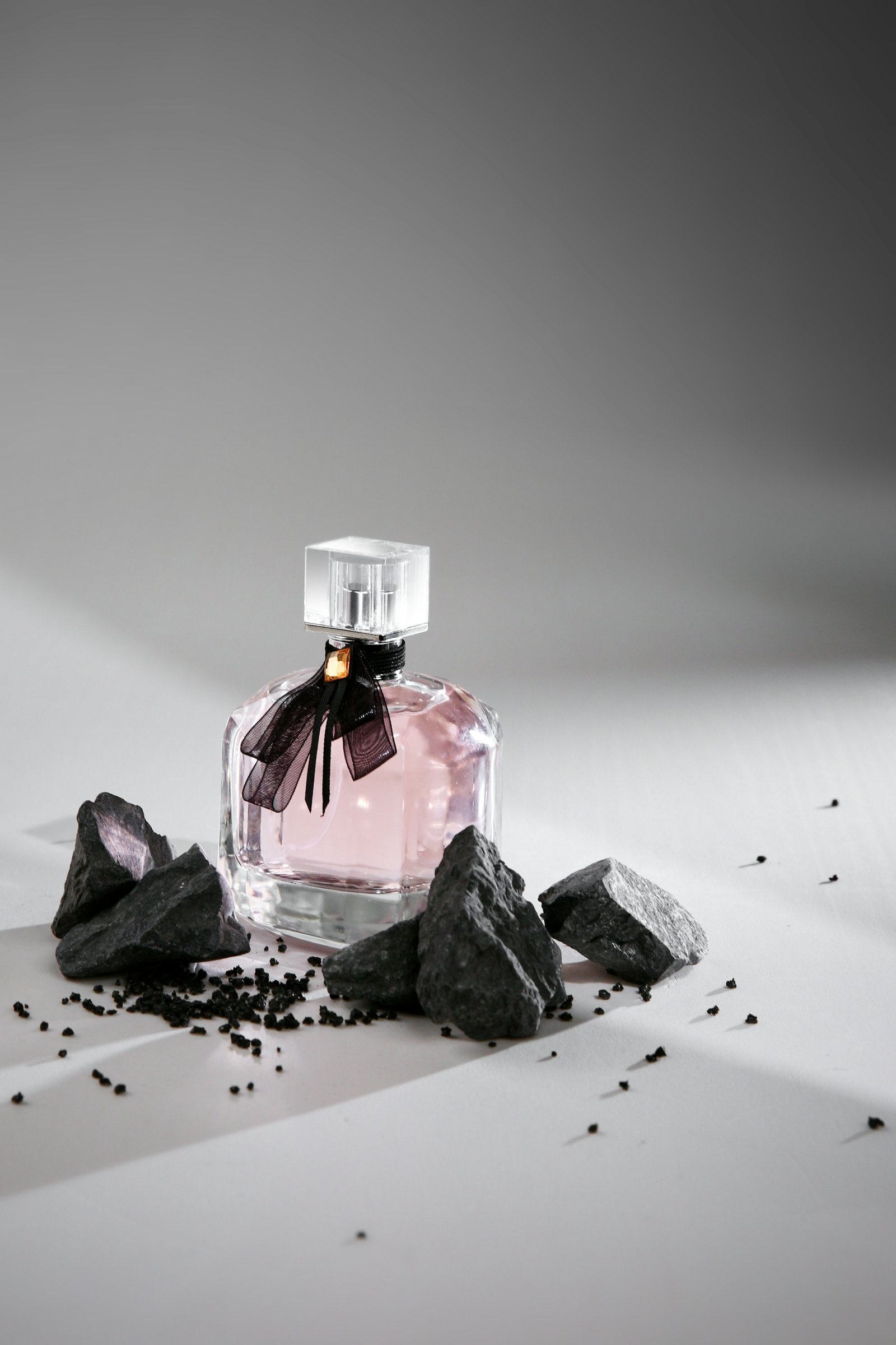 Perfume bottle arranged on stones