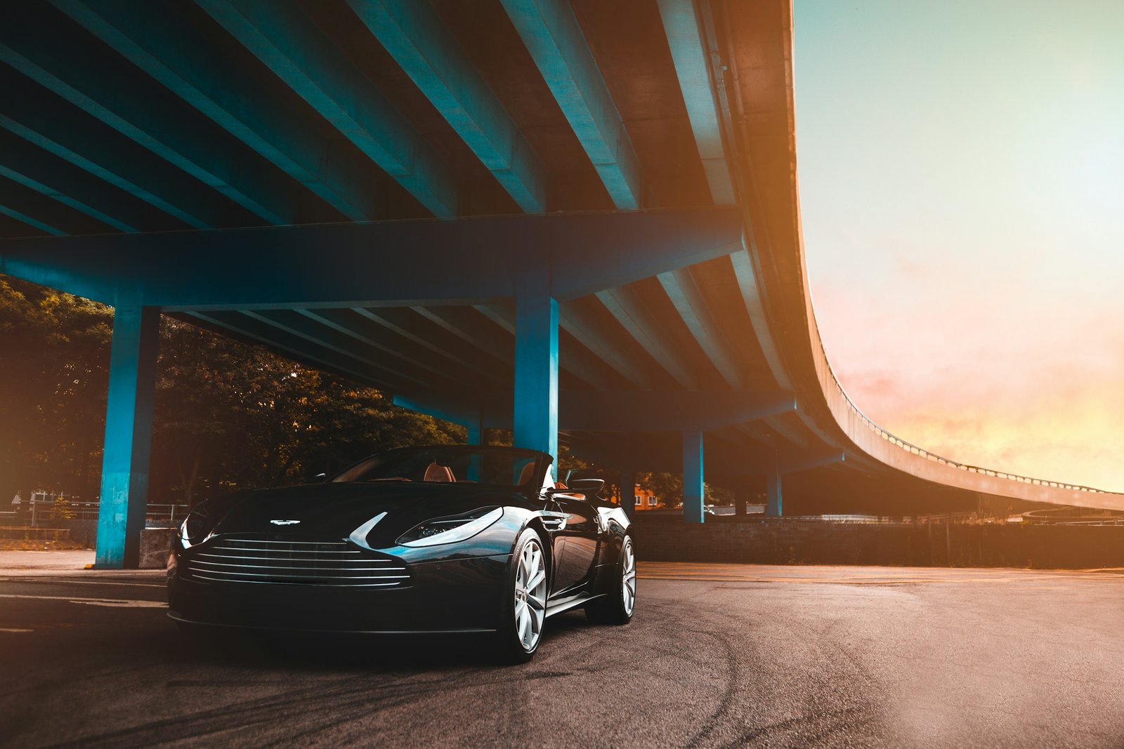 Sports car beneath a modern bridge