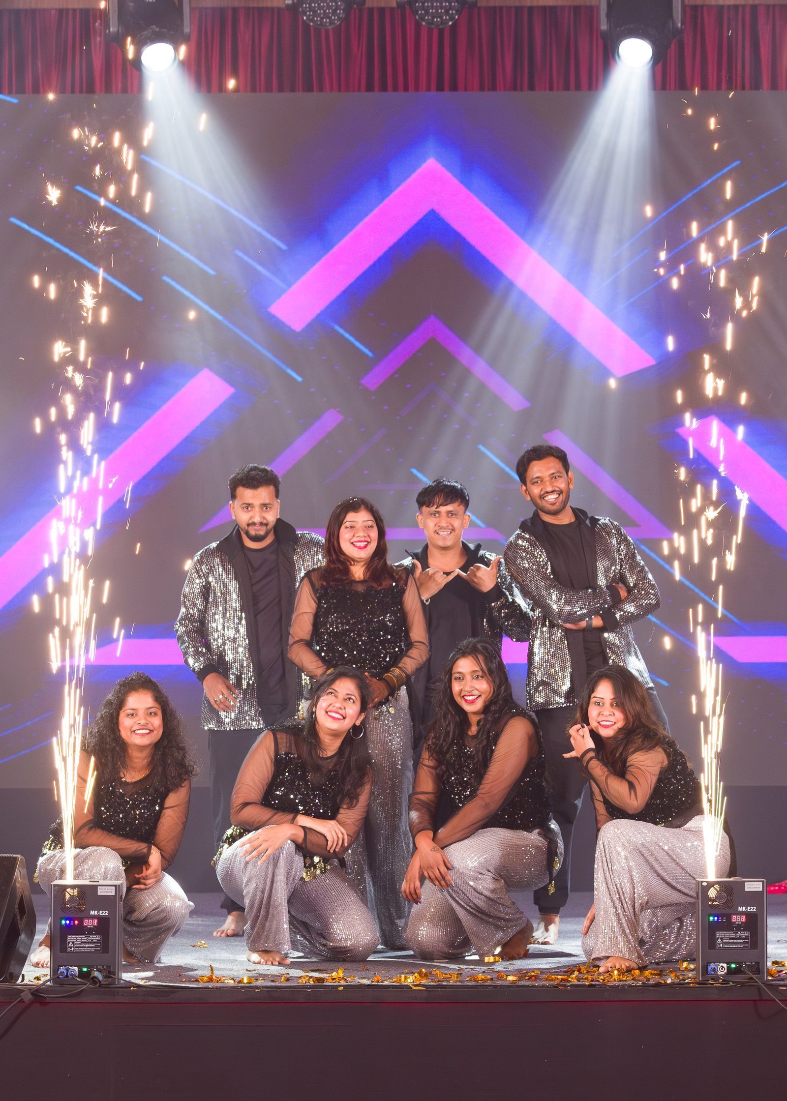 Group celebrating on a brightly lit event stage