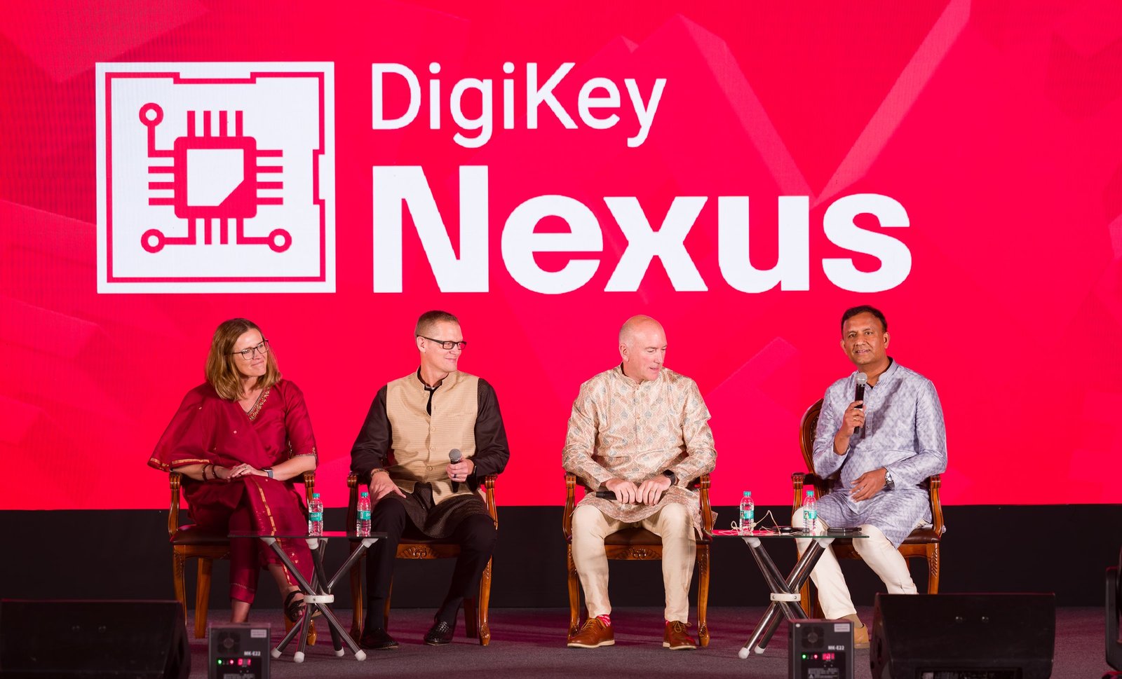 Panellists seated on a conference stage