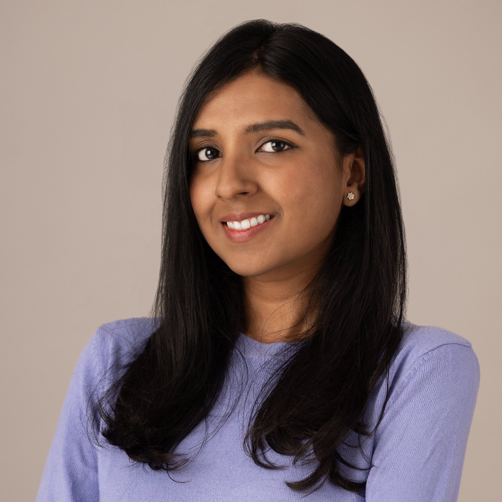 Professional portrait of a woman in a lavender blouse