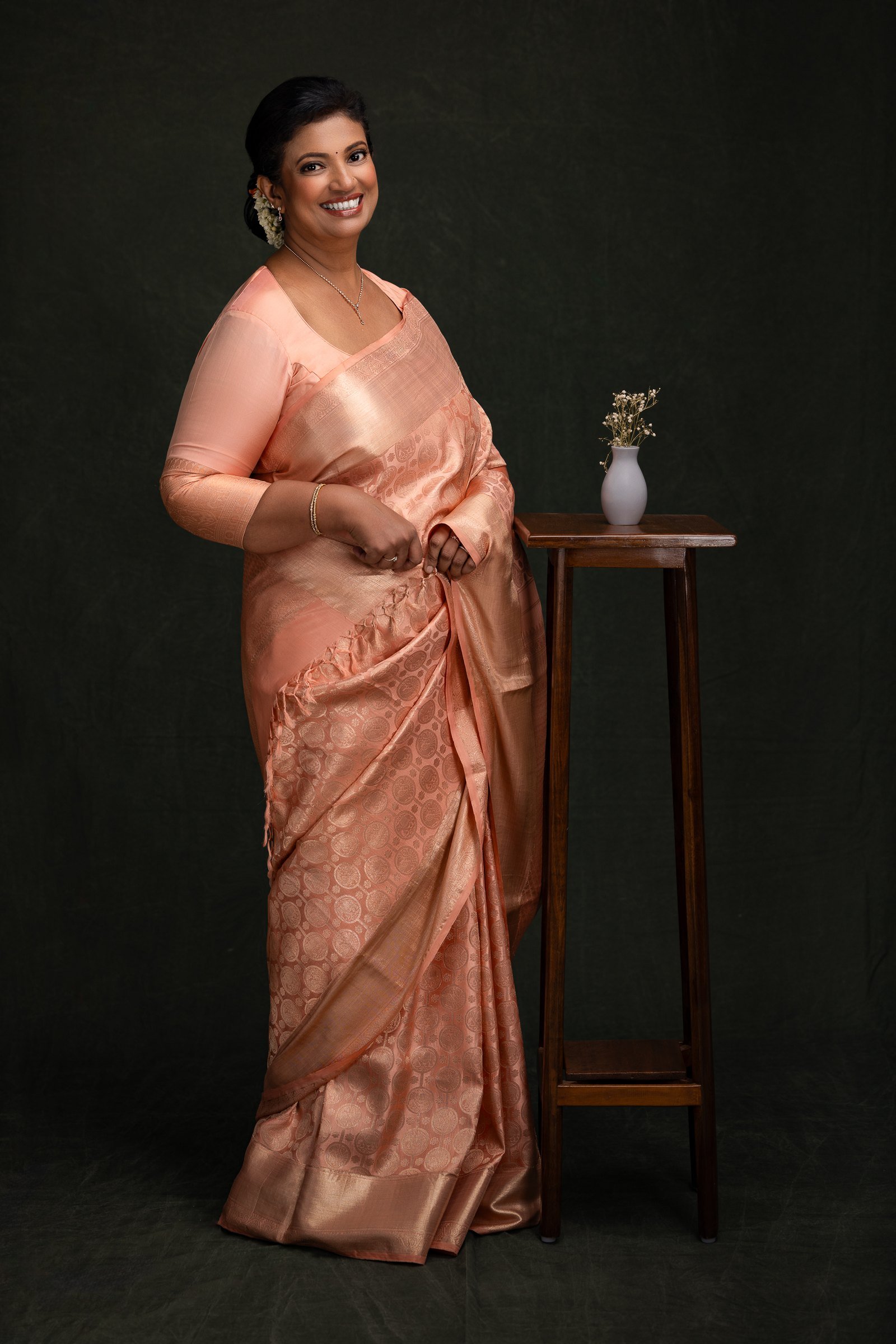 Portrait of a woman wearing a peach saree